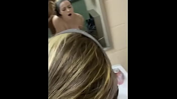 A lovely girl is bent over in a public restroom sink and moans loudly